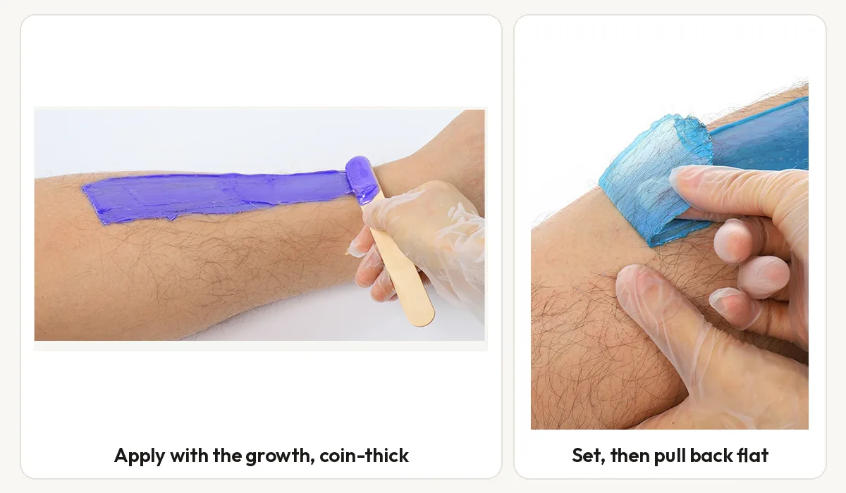 Lavender hard wax applied along a forearm with a wooden applicator, and a set blue wax film being pulled back flat against the skin